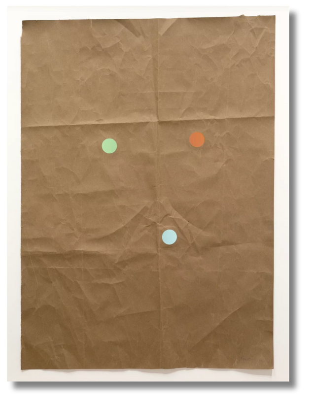 A crumpled brown paper composition with three pastel dots, minimalist and playful—reflecting the French appreciation for nuance, restraint, and conceptual wit.