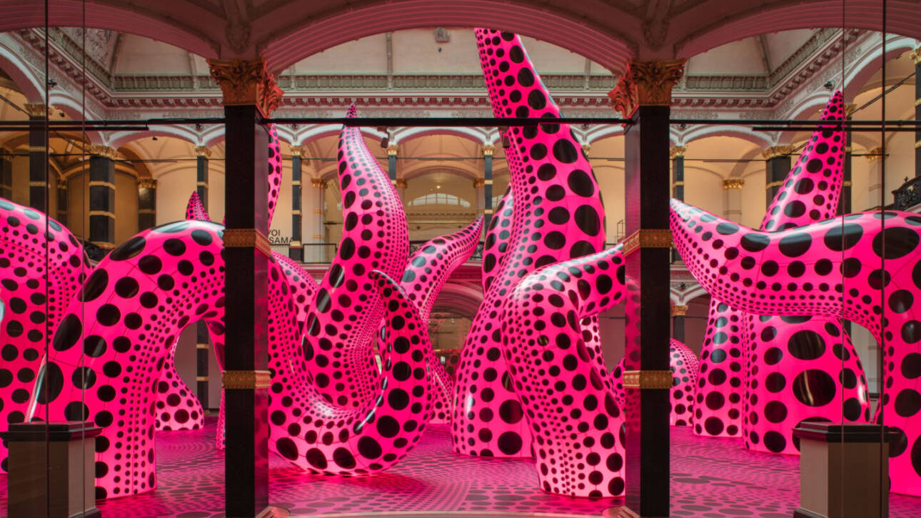 Installation view of Yayoi Kusama's inflatable tentacle sculptures in vivid pink with black polka dots, exhibited at Gropius Bau, 2021.