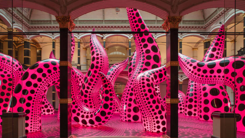 Installation view of Yayoi Kusama's inflatable tentacle sculptures in vivid pink with black polka dots, exhibited at Gropius Bau, 2021.