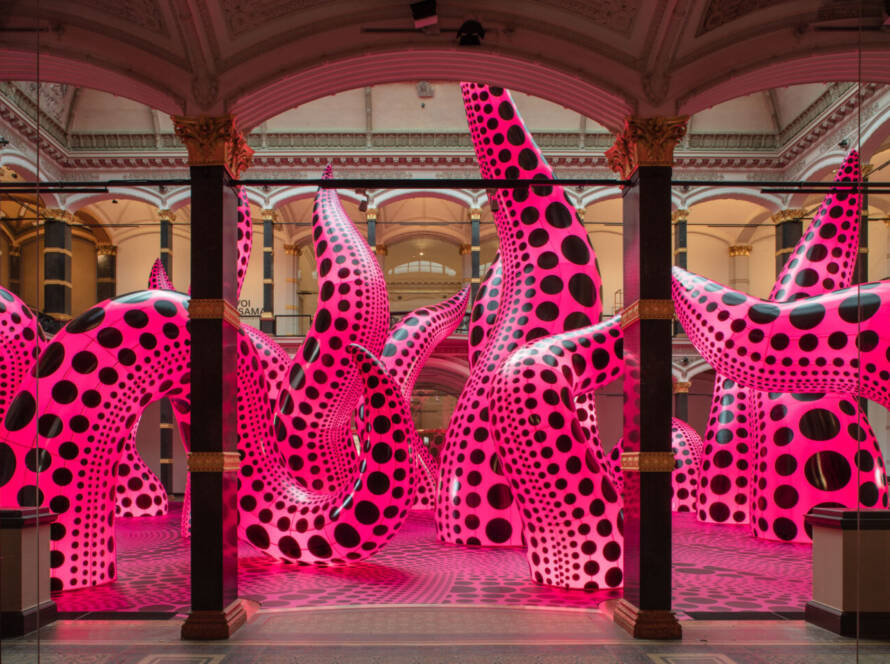 Installation view of Yayoi Kusama's inflatable tentacle sculptures in vivid pink with black polka dots, exhibited at Gropius Bau, 2021.