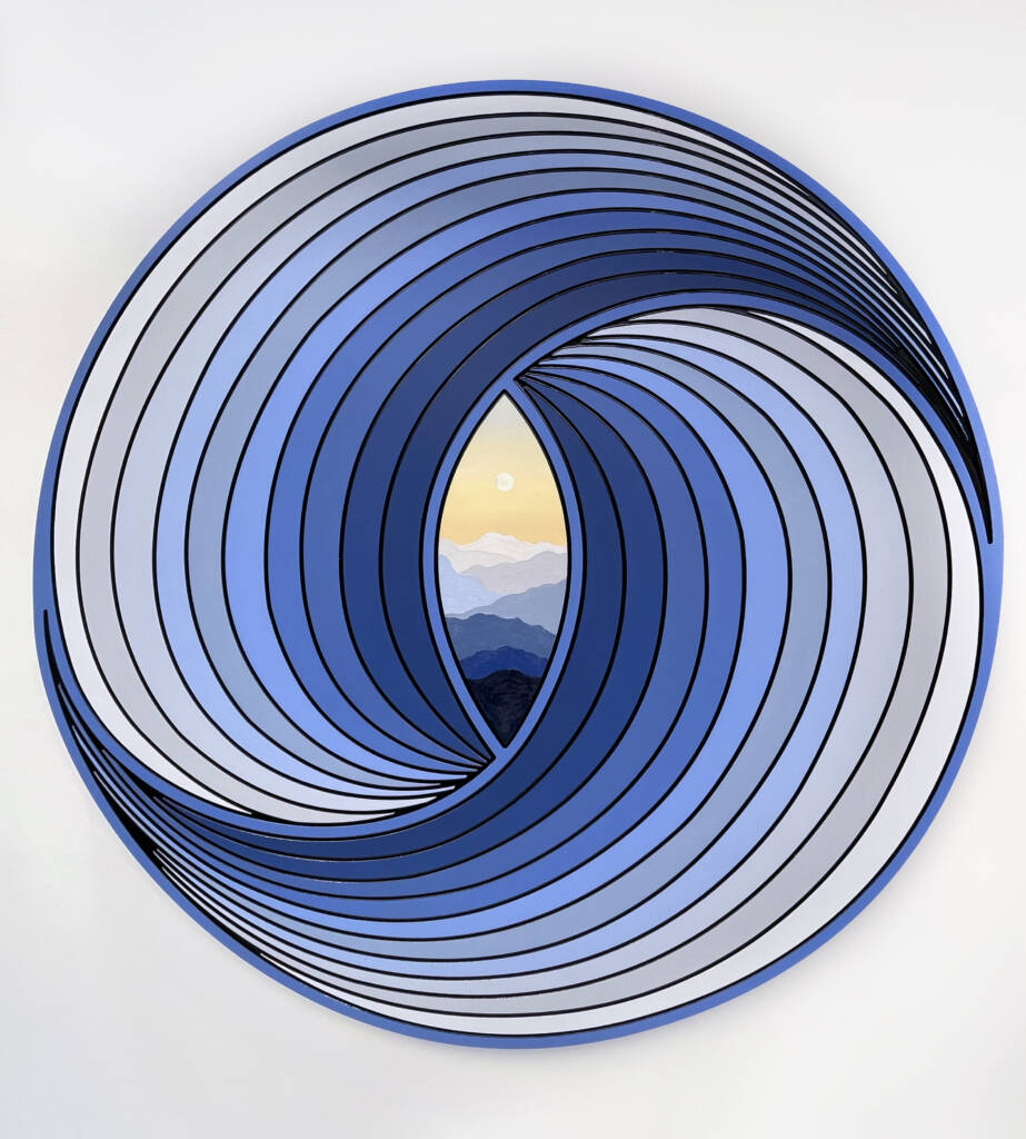 Blue circular sculpture with mountain sunset