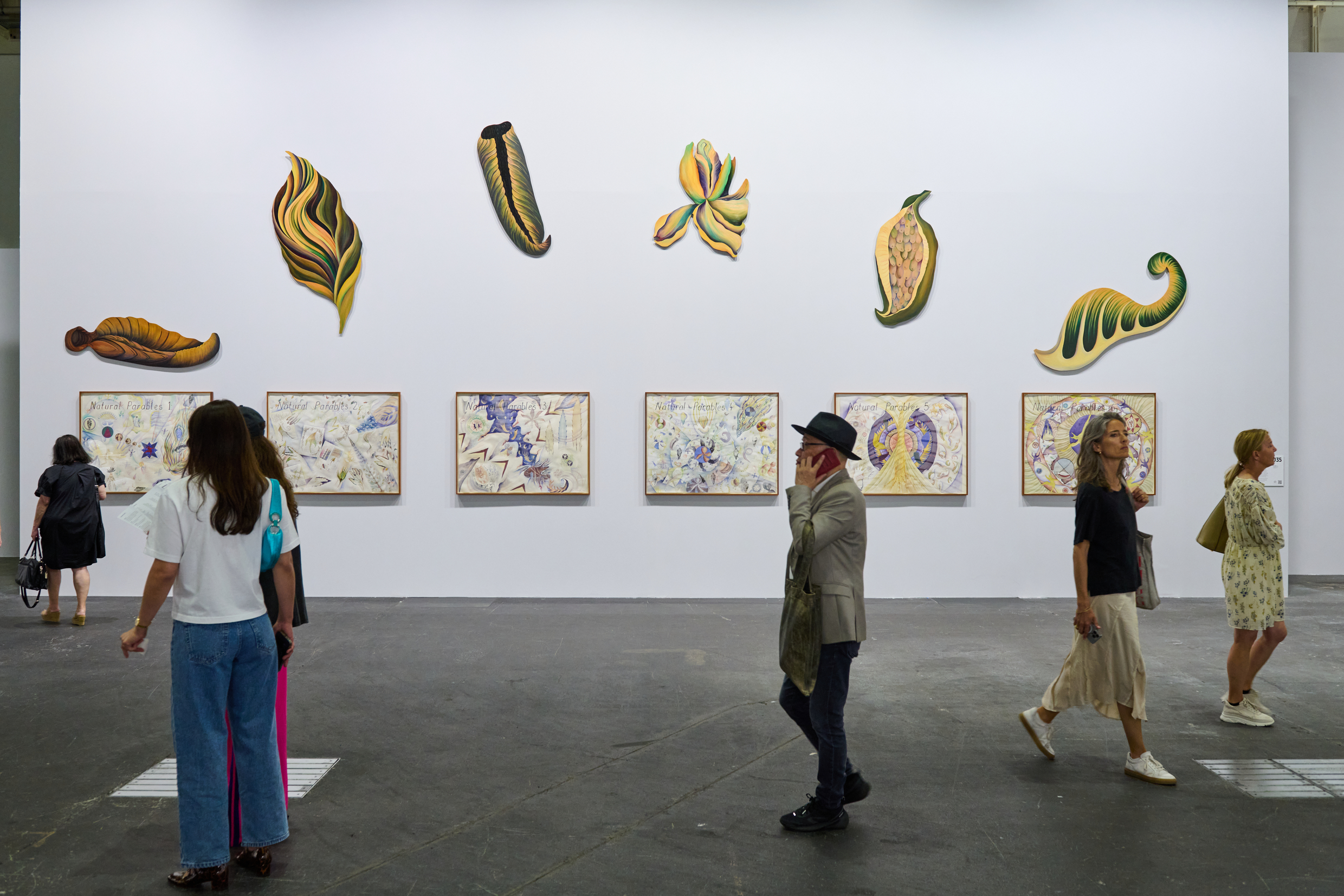 Exhibition of Faith Wilding’s works at Art Basel 2025, presented by Anat Ebgi gallery—visitors engaging with botanical and symbolic mixed media pieces.